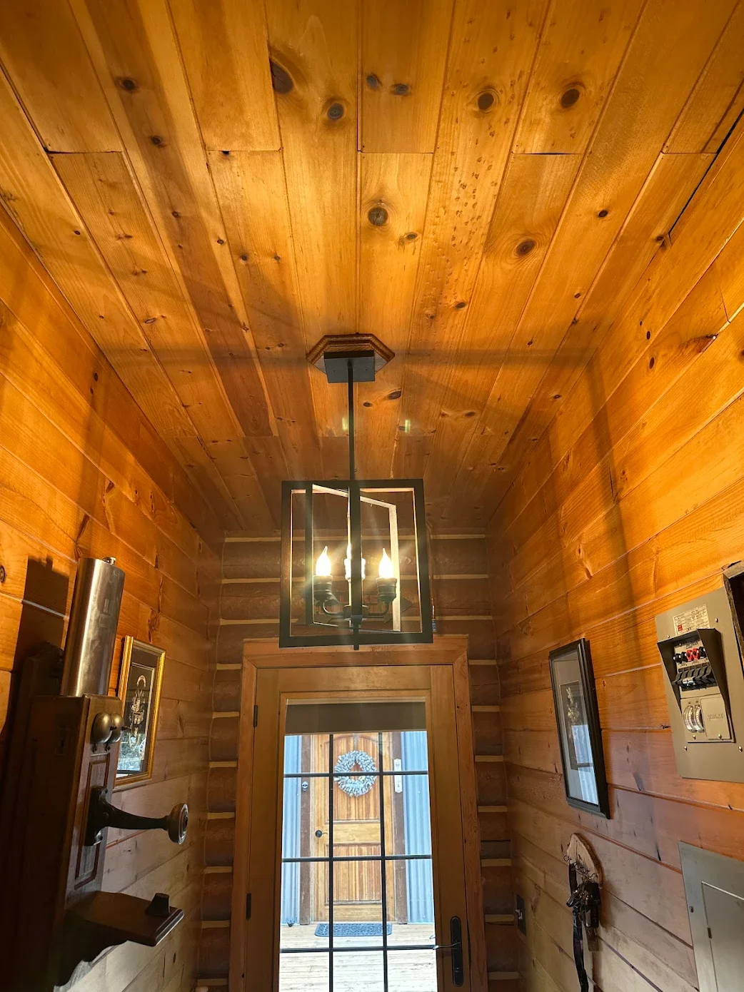 Hanging light fixture installed in entryway during home retrofit in North Idaho