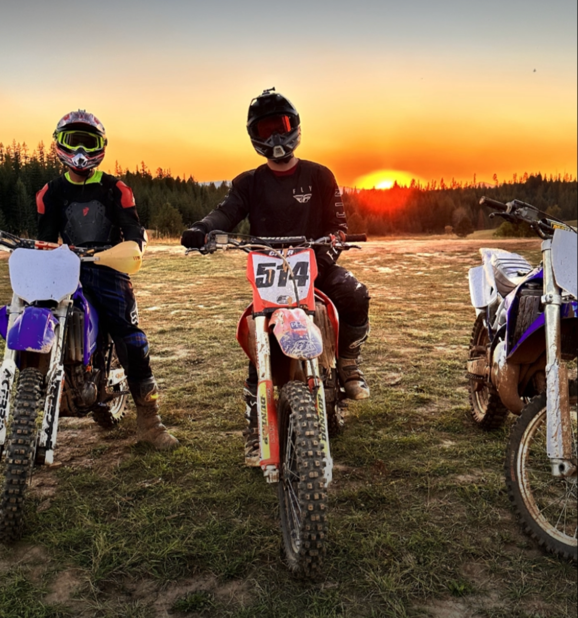 Honest Electric team enjoying downtime riding dirt bikes at sunset in Christmas Hills Idaho