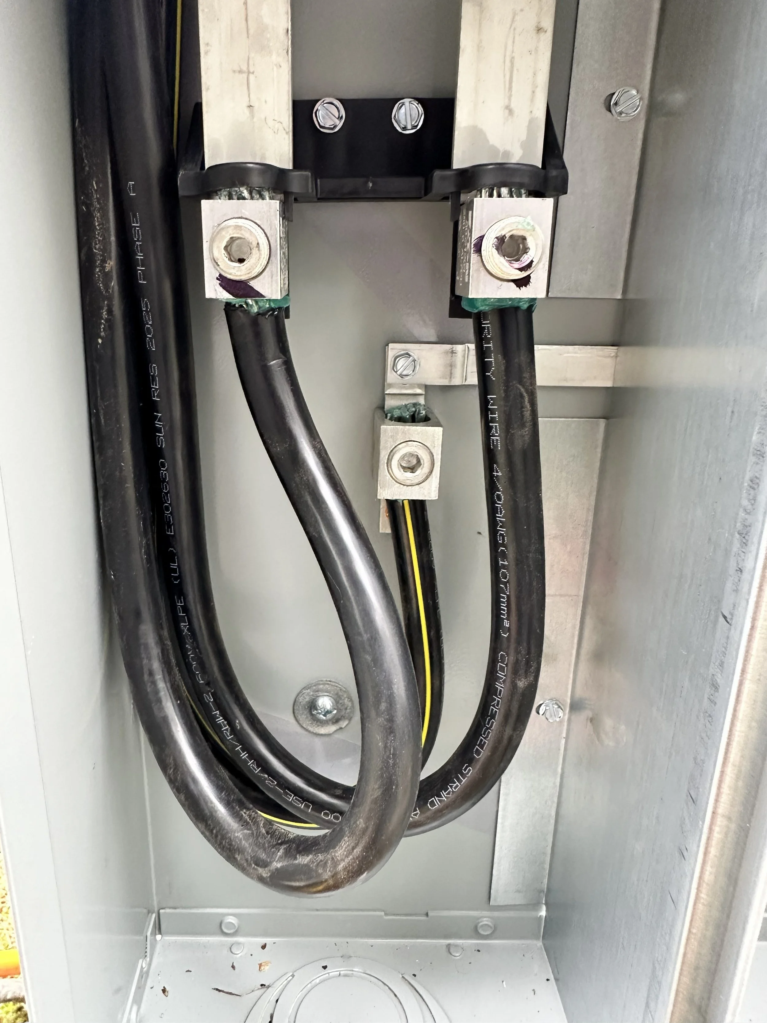 Close-up of electrical wires and connectors inside an electrical panel or box.