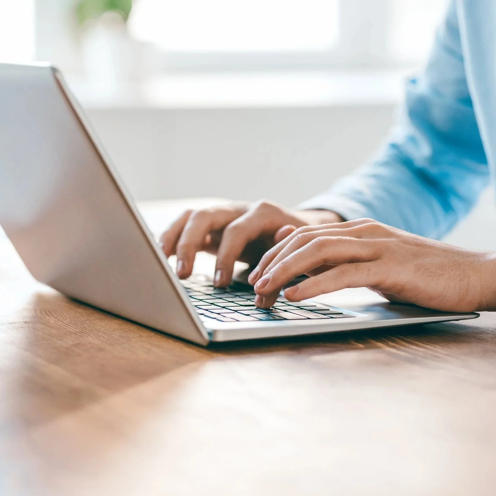 Hands typing on computer