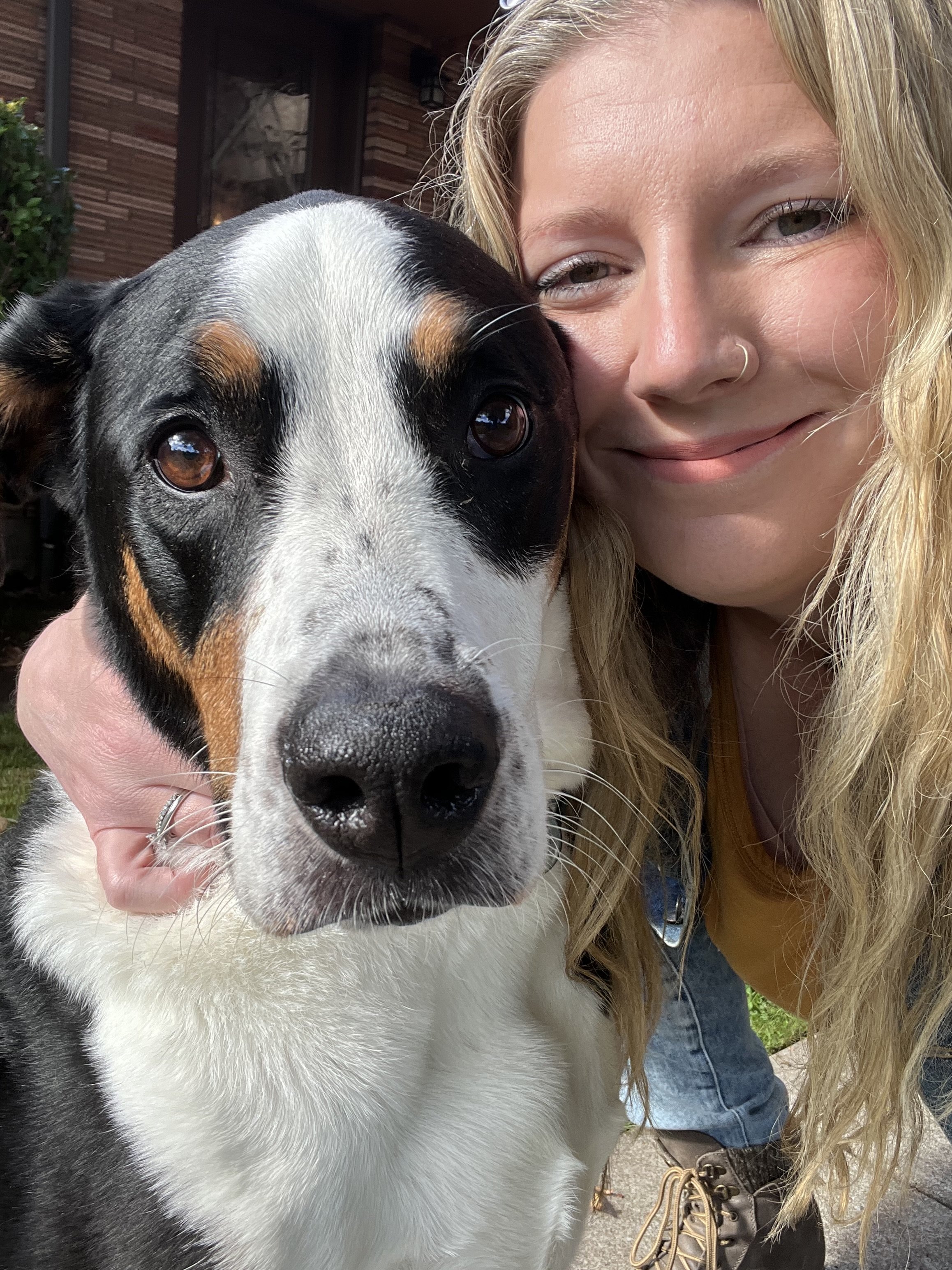 local portland pet sitter hugging a dog on a walk