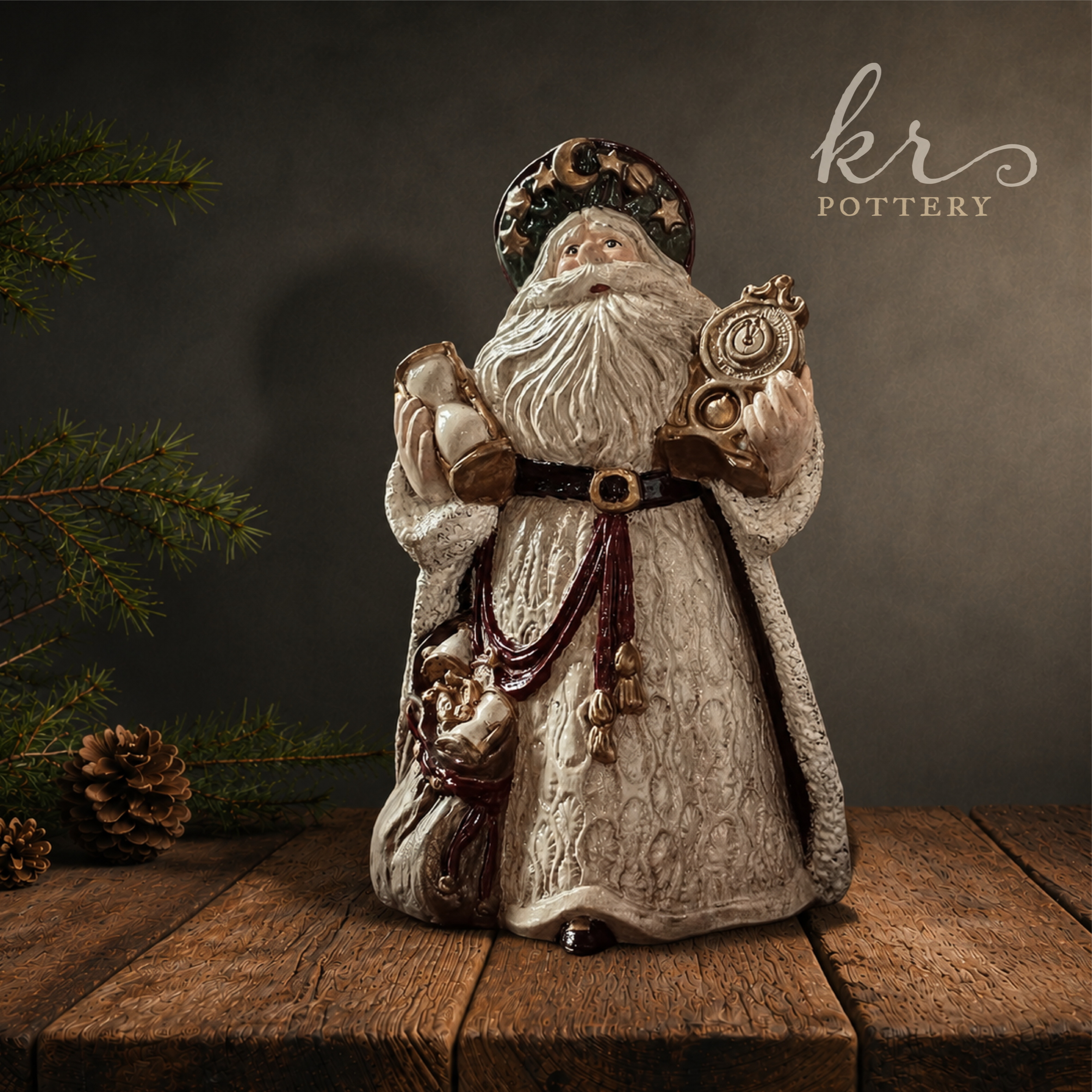 Ceramic Santa Claus figurine with a white beard, holding a clock, standing on a wooden surface, with pine branches and cones in the background, and the text 'kris POTTERY' on the wall.