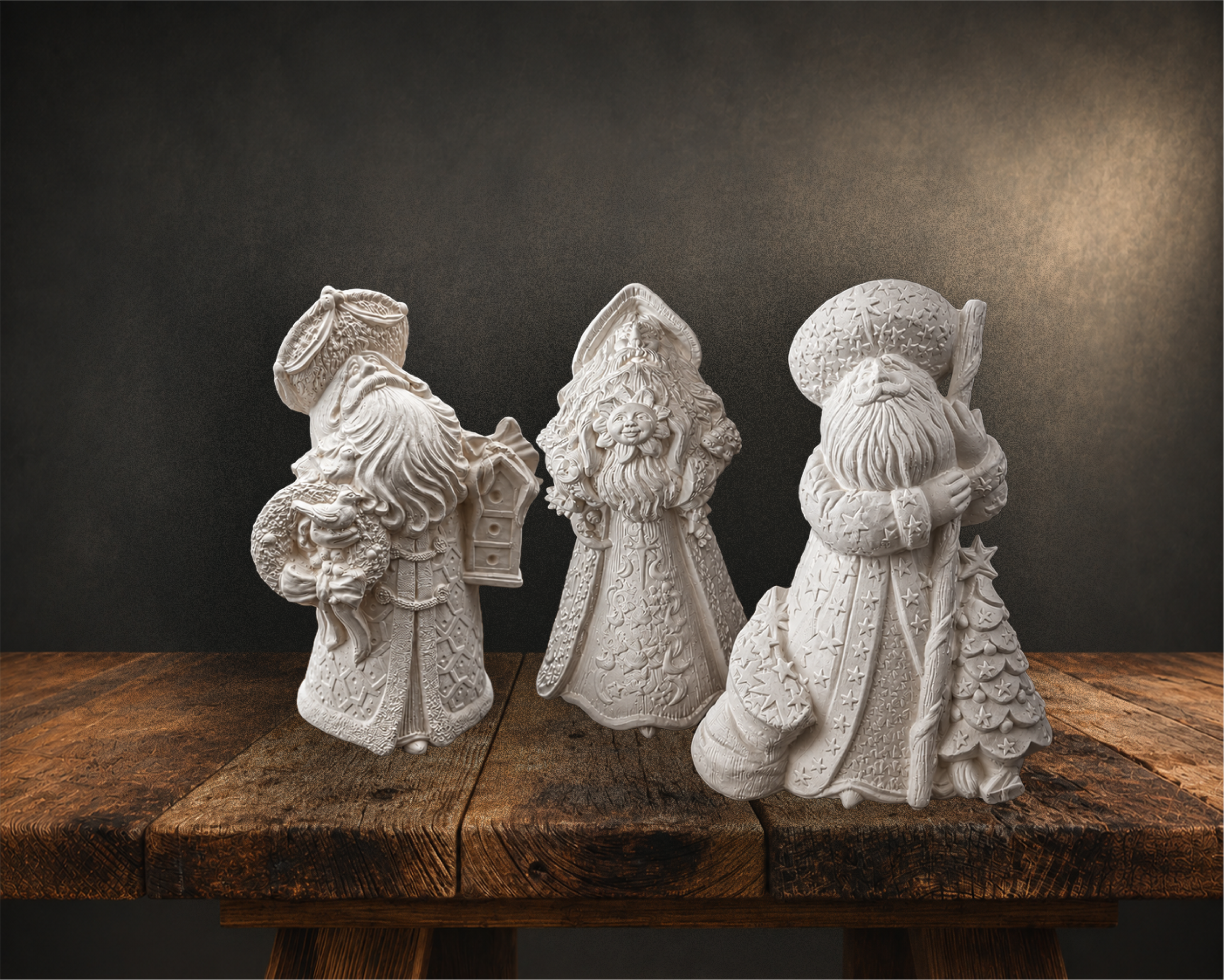 White ceramic figurines of three wise men or kings, each holding a gift, placed on a wooden surface against a dark background.