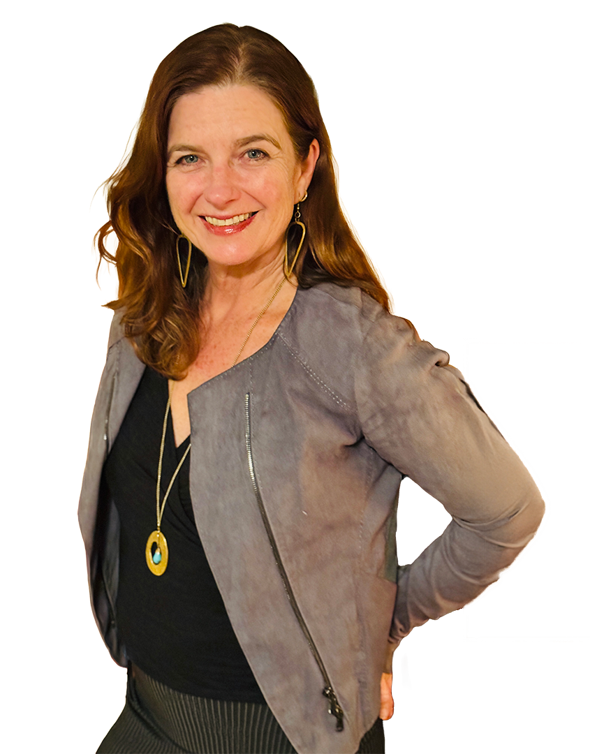 A photo of Jennifer Pickering with shoulder-length red hair smiling, wearing a gray jacket over a black top, with gold jewelry including earrings and a necklace, standing against a multicolored background.