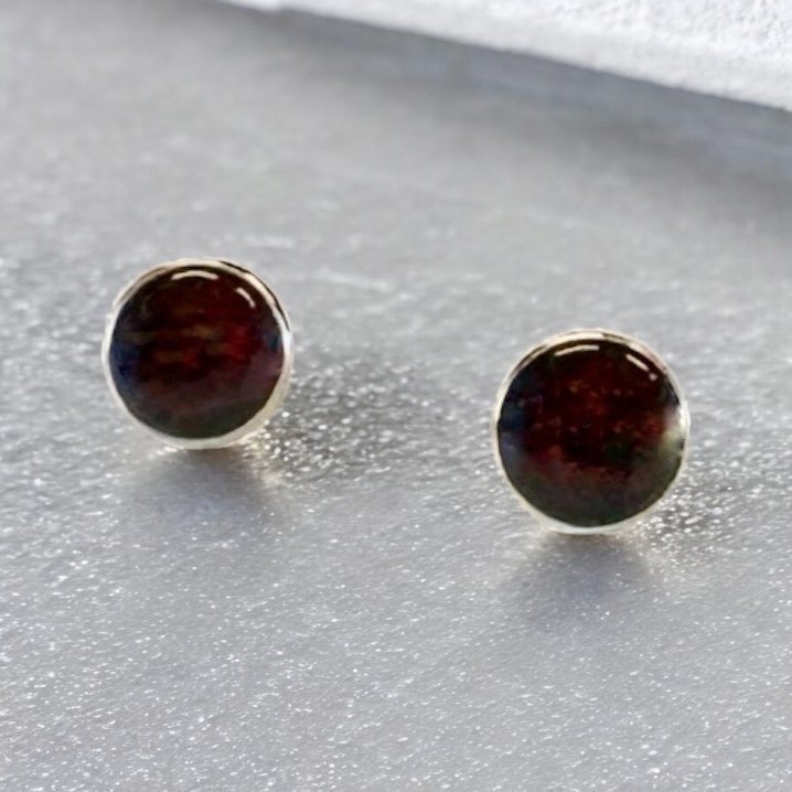 Garnet stud earrings in sterling silver bezels.
