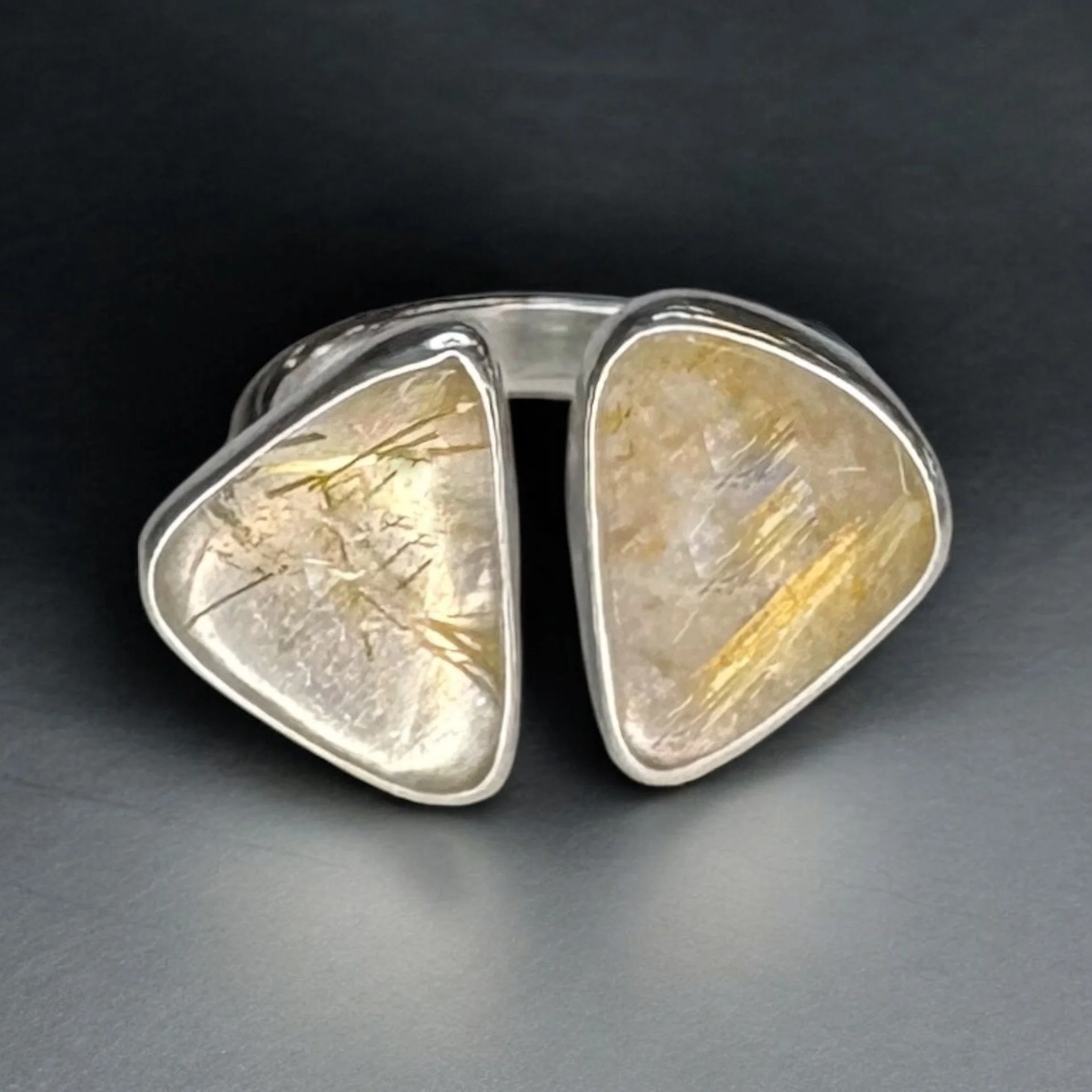 Rutilated quartz set in a sterling silver adjustable ring.