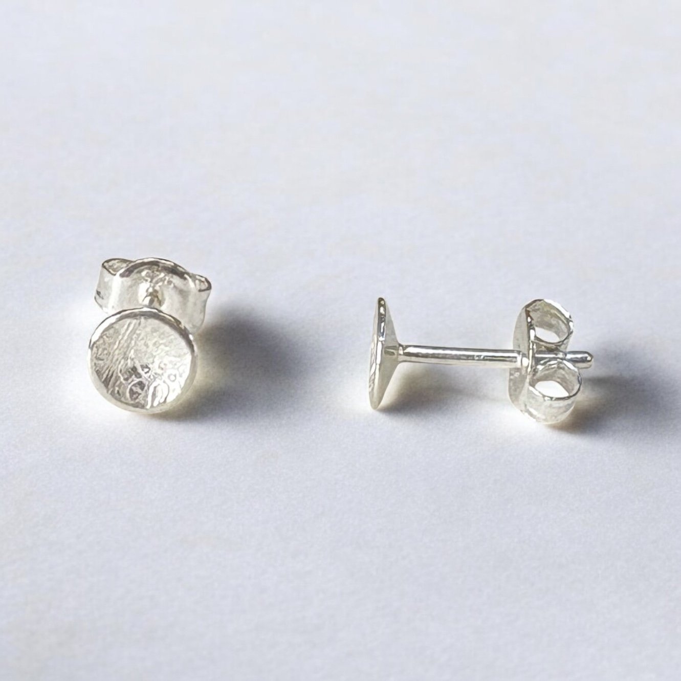 Textured sterling silver disk studs.