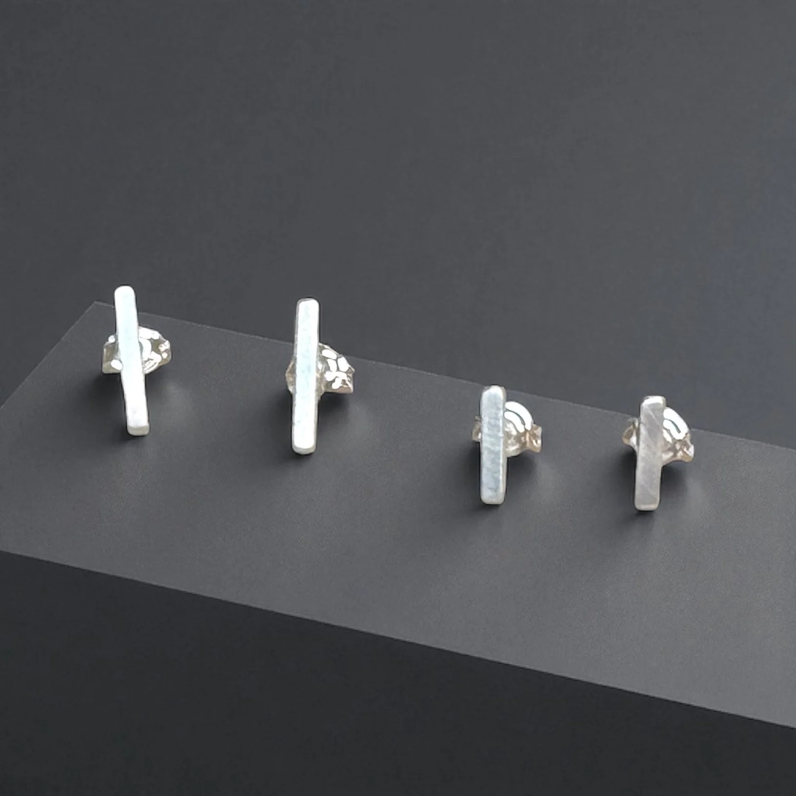 Sterling silver bar stud earrings.