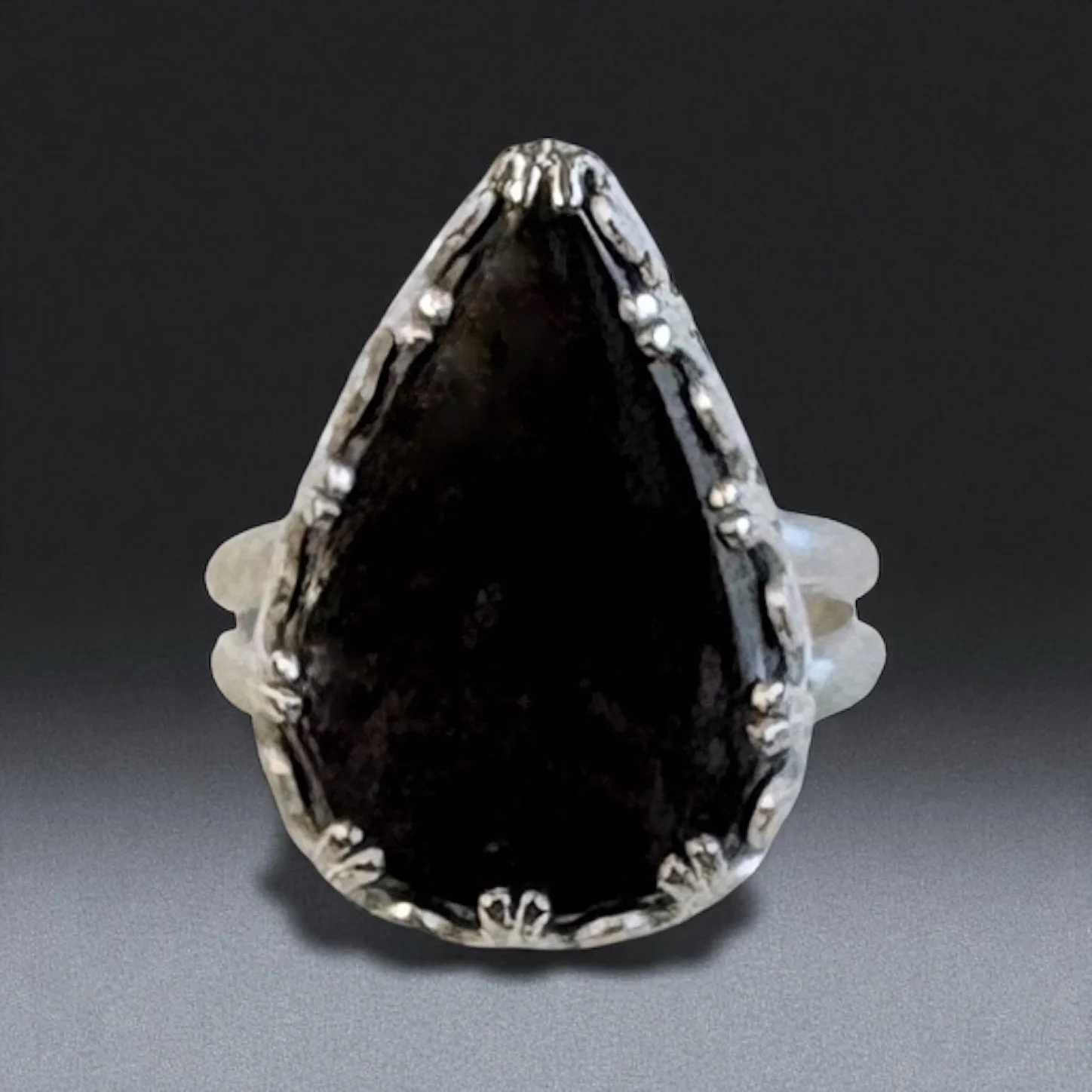 Purple sheen obsidian in a sterling silver ring with a detailed bezel.
