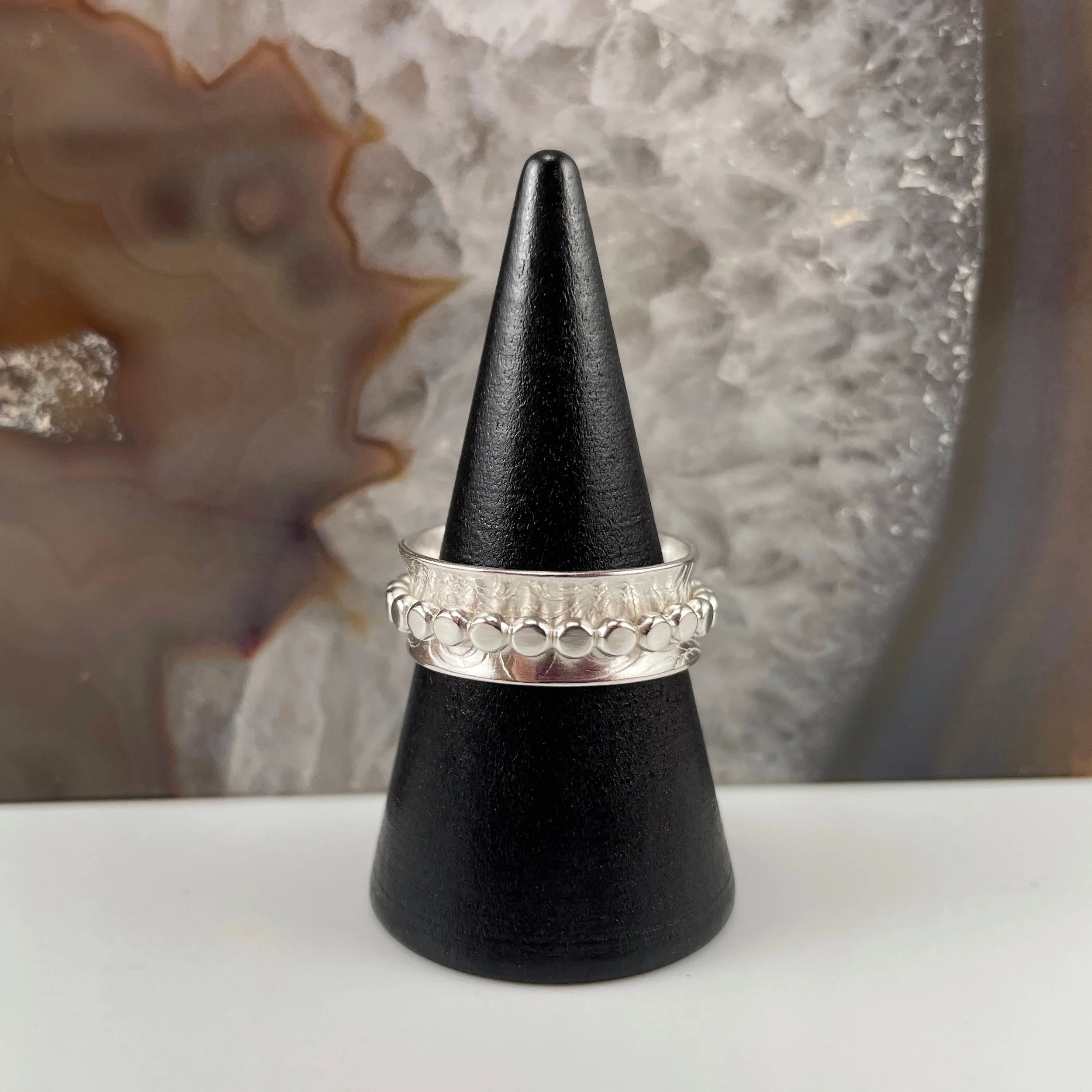 Sterling silver spinner ring with beaded detail.