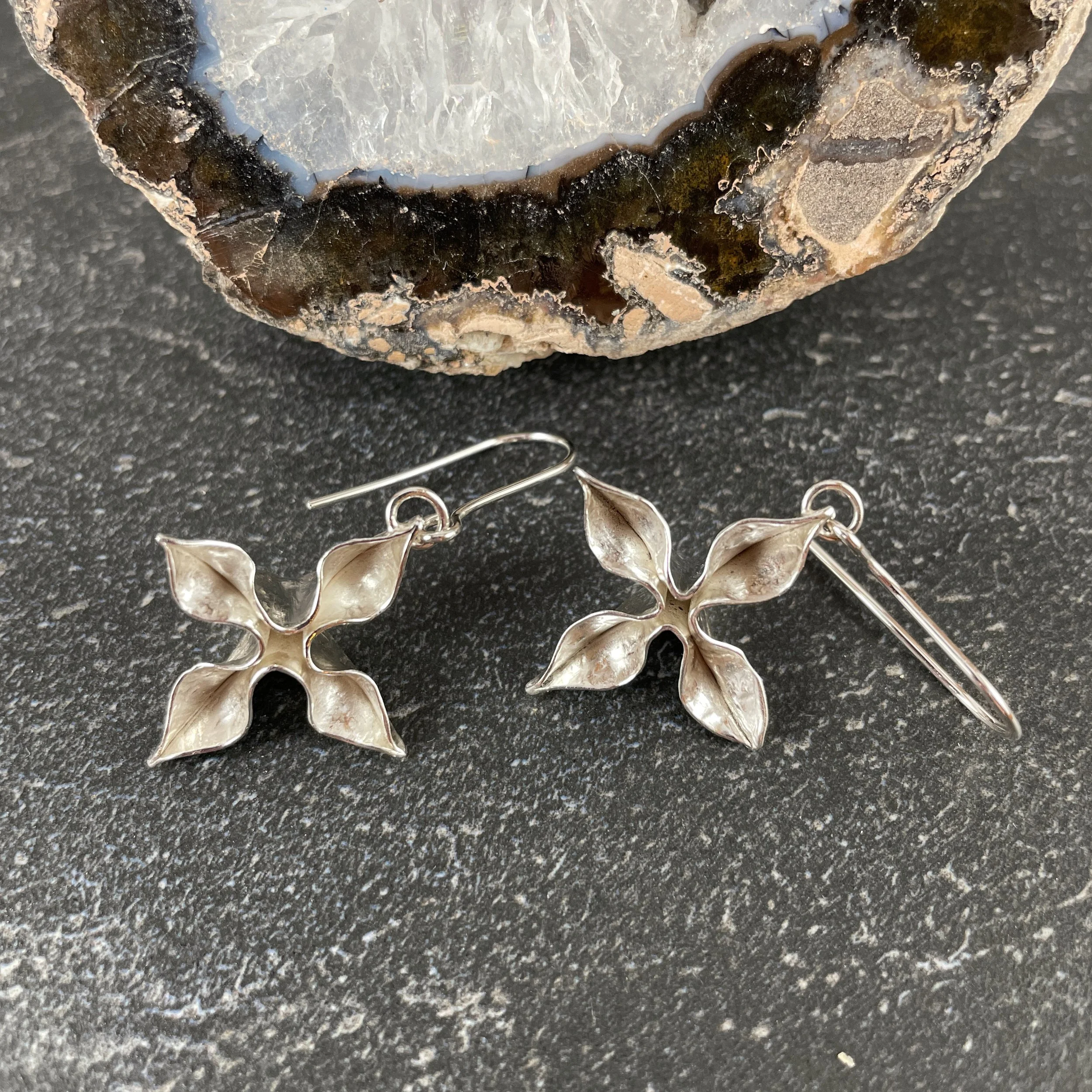Fold‑formed sterling silver earrings in a star design.