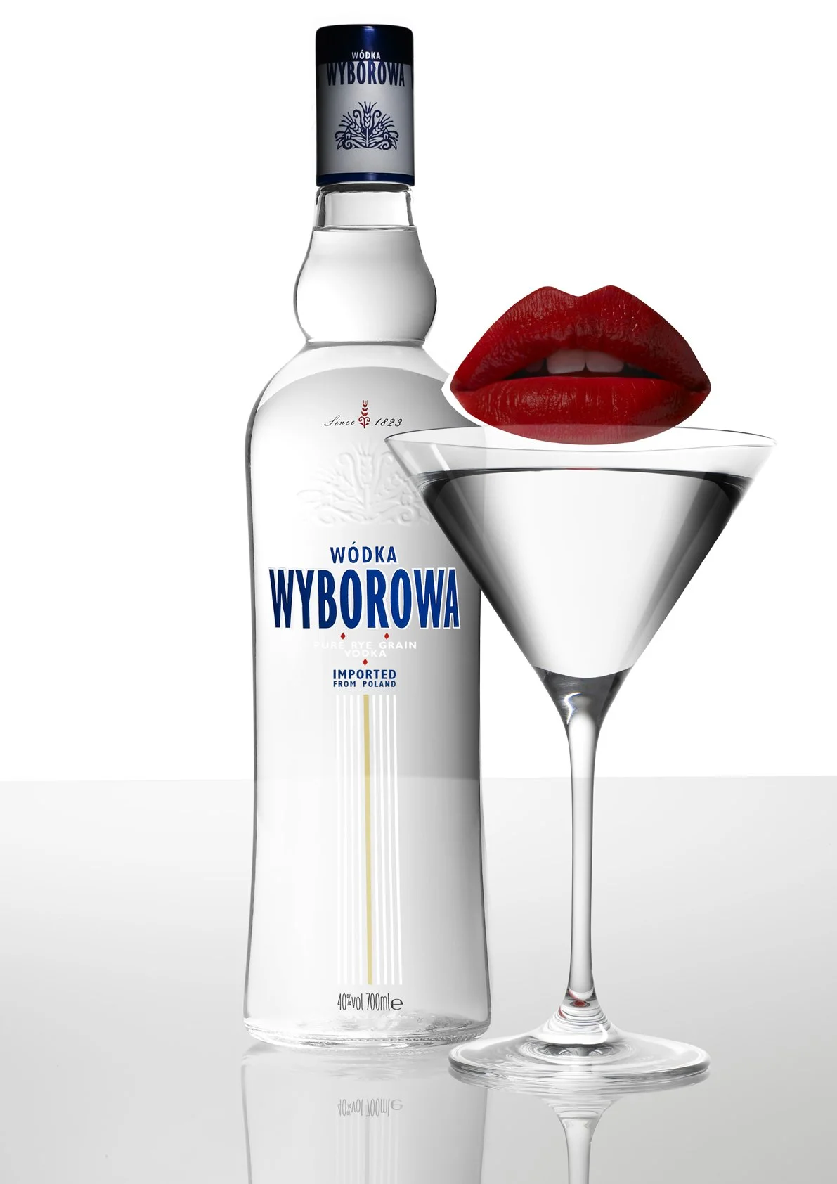A bottle of Wyborka vodka with a martini glass containing a pair of lips with red lipstick, and a small bite showing teeth. Advertising. Producer. Miranda Kendrick.