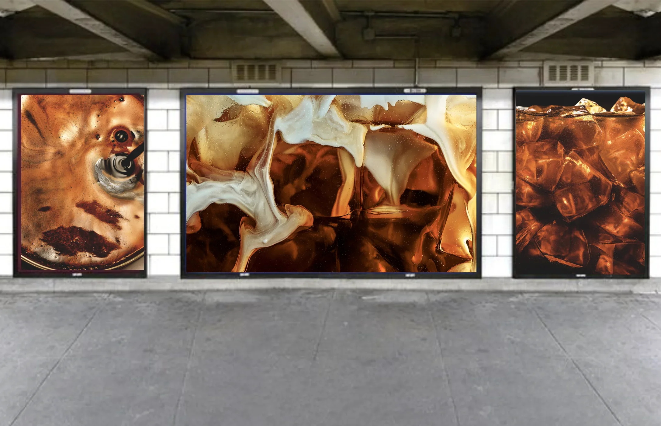 Three framed abstract art posters featuring swirling coffee, cream, and ice cubes, displayed on a concrete wall in an industrial-style gallery.