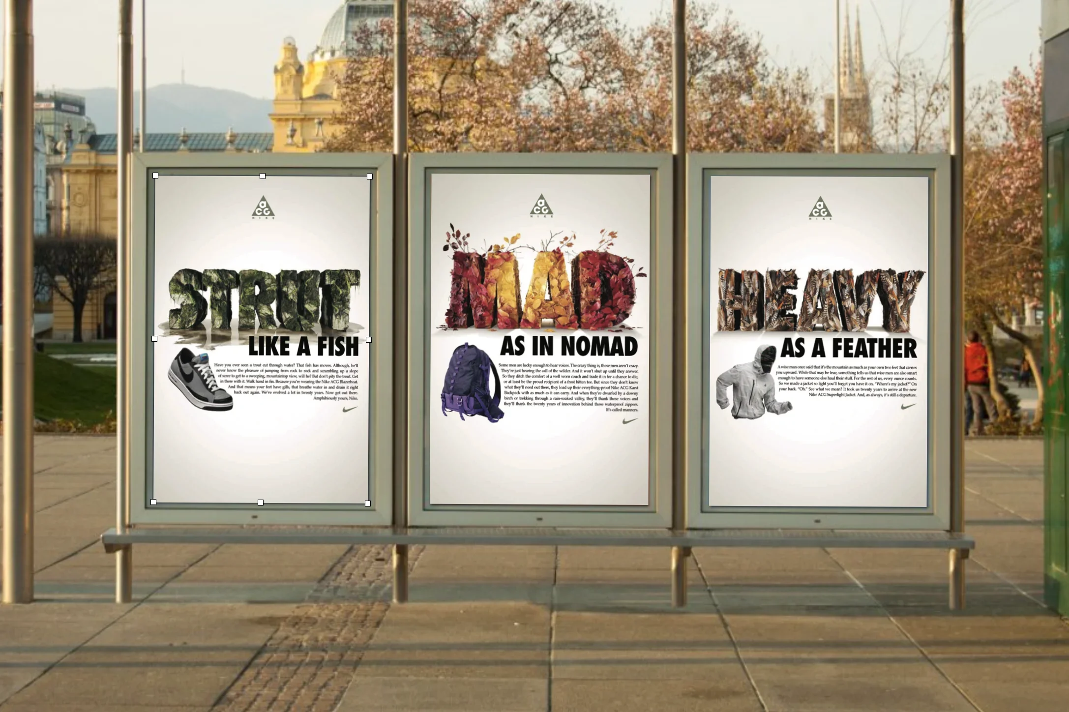 Three posters on a outdoor stand, each with a nature-inspired word: "STREY" like a fish, "MAD" as in nomad, and "HEAVY" as a feather, with descriptive text and a Nike logo at the bottom.