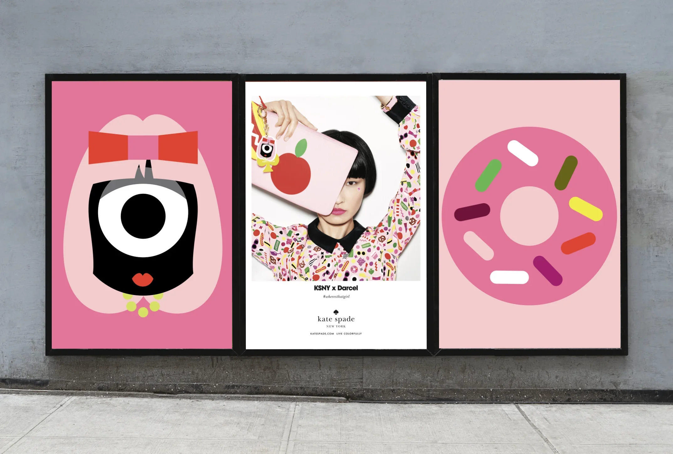 Three posters on a gray wall featuring colorful, abstract graphics. The first depicts a face with a large eye, pink hair, red bow, and green necklace. The middle poster shows a woman holding a pink bag with a red apple design, partially covering her face. The third has a pink background with a circular shape decorated with multicolored oval and capsule shapes.