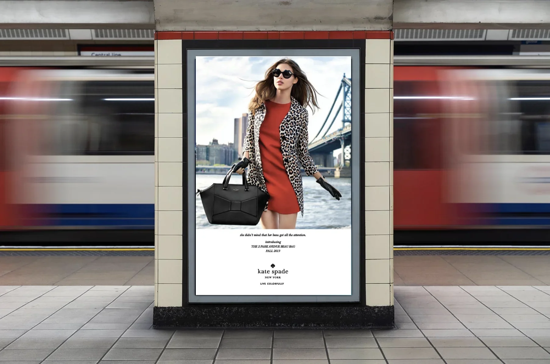 Fashion advertisement featuring a woman in a red dress and leopard print coat holding a black handbag, standing outdoors near a river with a bridge in the background.