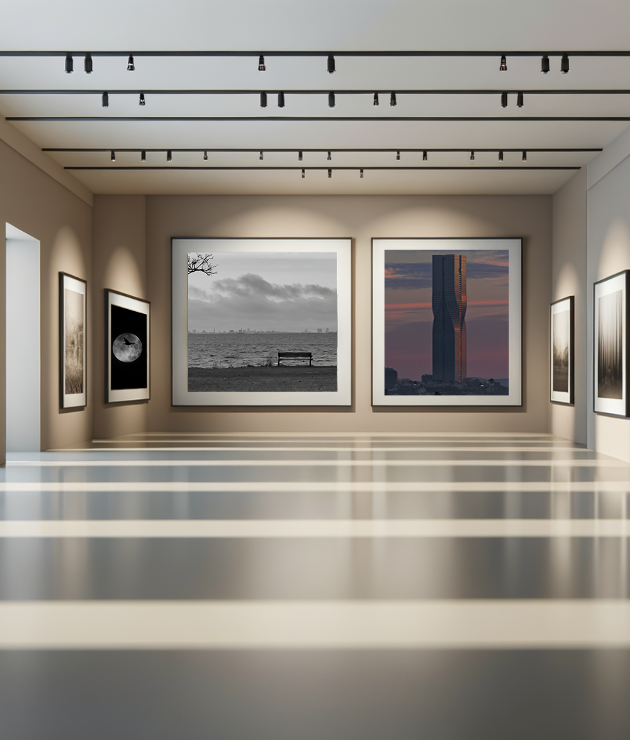 Gallery with black and white photographs, including a bench by the water, city skyline, and a modern skyscraper.