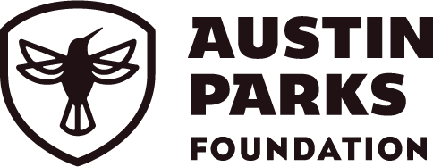 Logo of Austin Parks Foundation featuring a shield with a bird and the text 'Austin Parks Foundation'.