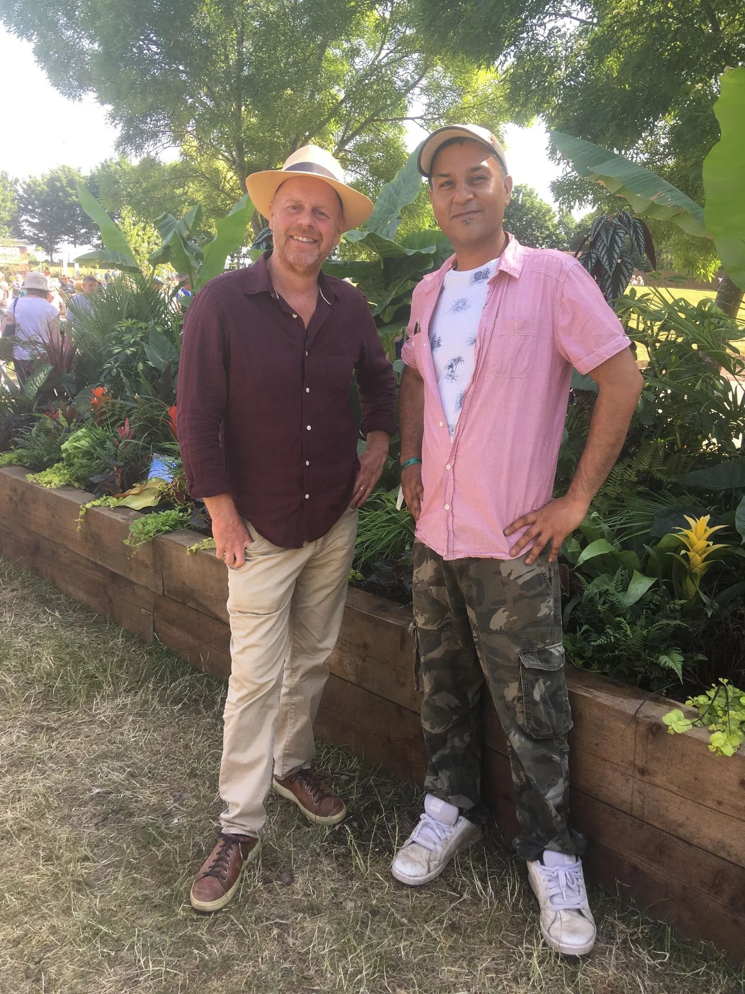 Hefty meeting Joe Swift from BBC, standing in front of lush green foliage jungle border