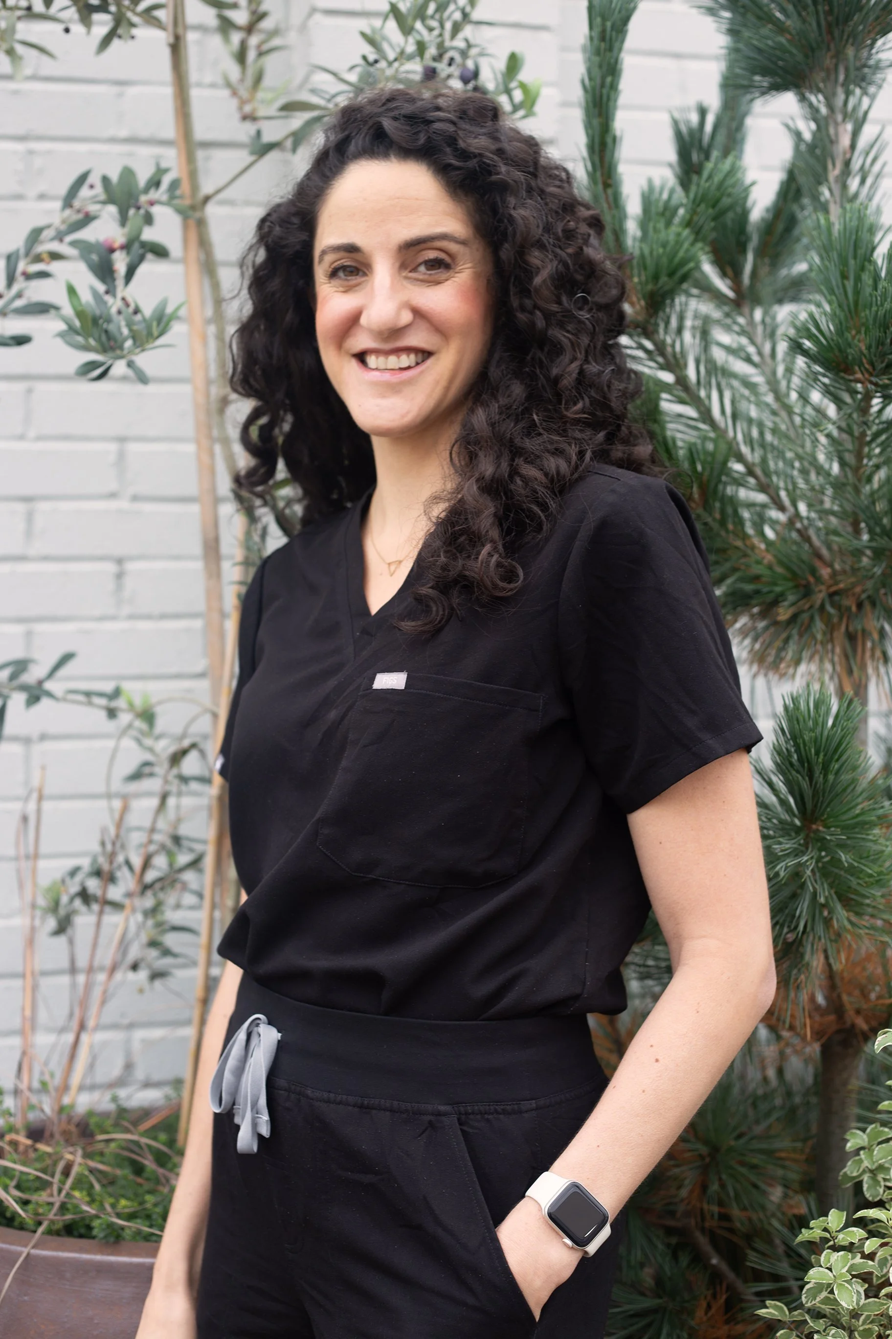 Acupuncturist Teresa Nicola in her scrubs smiling.