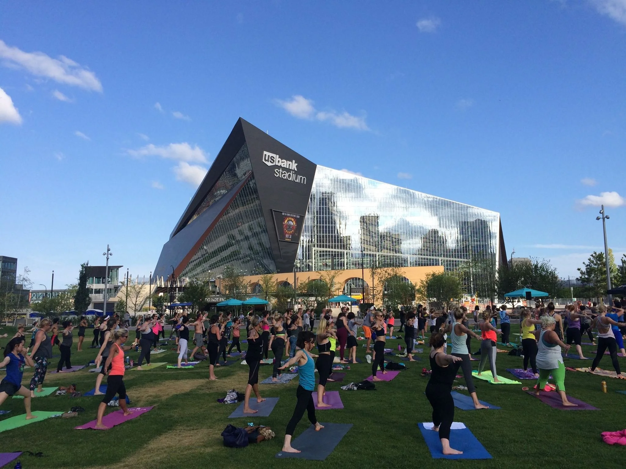 Outdoor yoga experience at Minneapolis Aquatennial near U.S. Bank Stadium featuring community wellness programming and experiential event activation