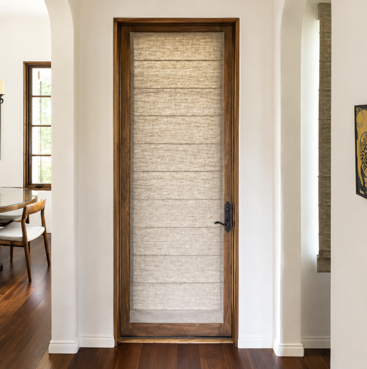Custom textured Roman shade on a wood-framed glass door in a warm modern interior