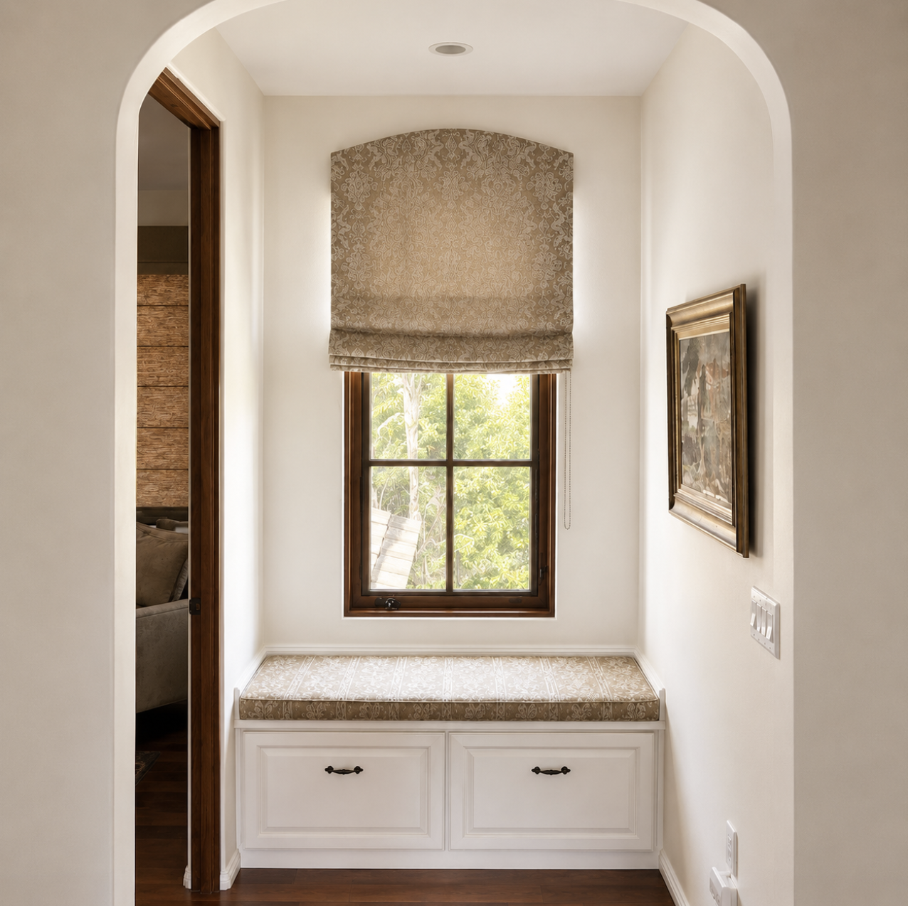Custom patterned Roman shade with matching window seat cushion in a cozy reading nook