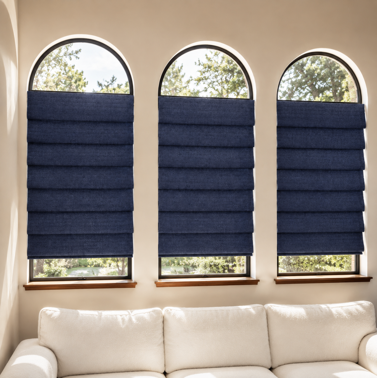 Custom navy Roman shades on arched windows in a modern living space