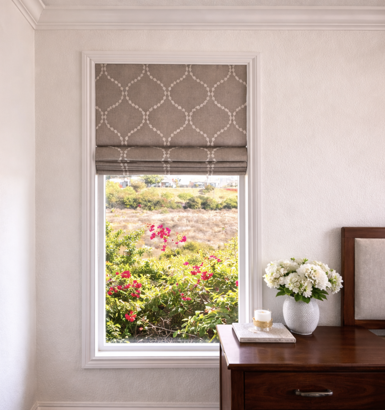 Custom roman shade with patterned fabric for bedroom window in San Diego home