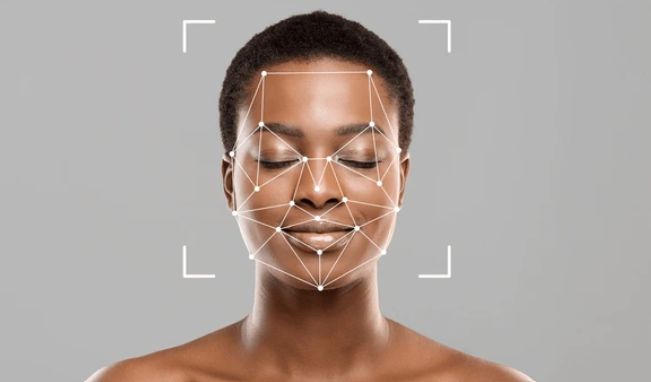 A woman receiving a professional skin analysis as a licensed esthetician examines her complexion and pores under magnification to assess skin type, acne, and aging concerns and create a customized facial and treatment plan for optimal results