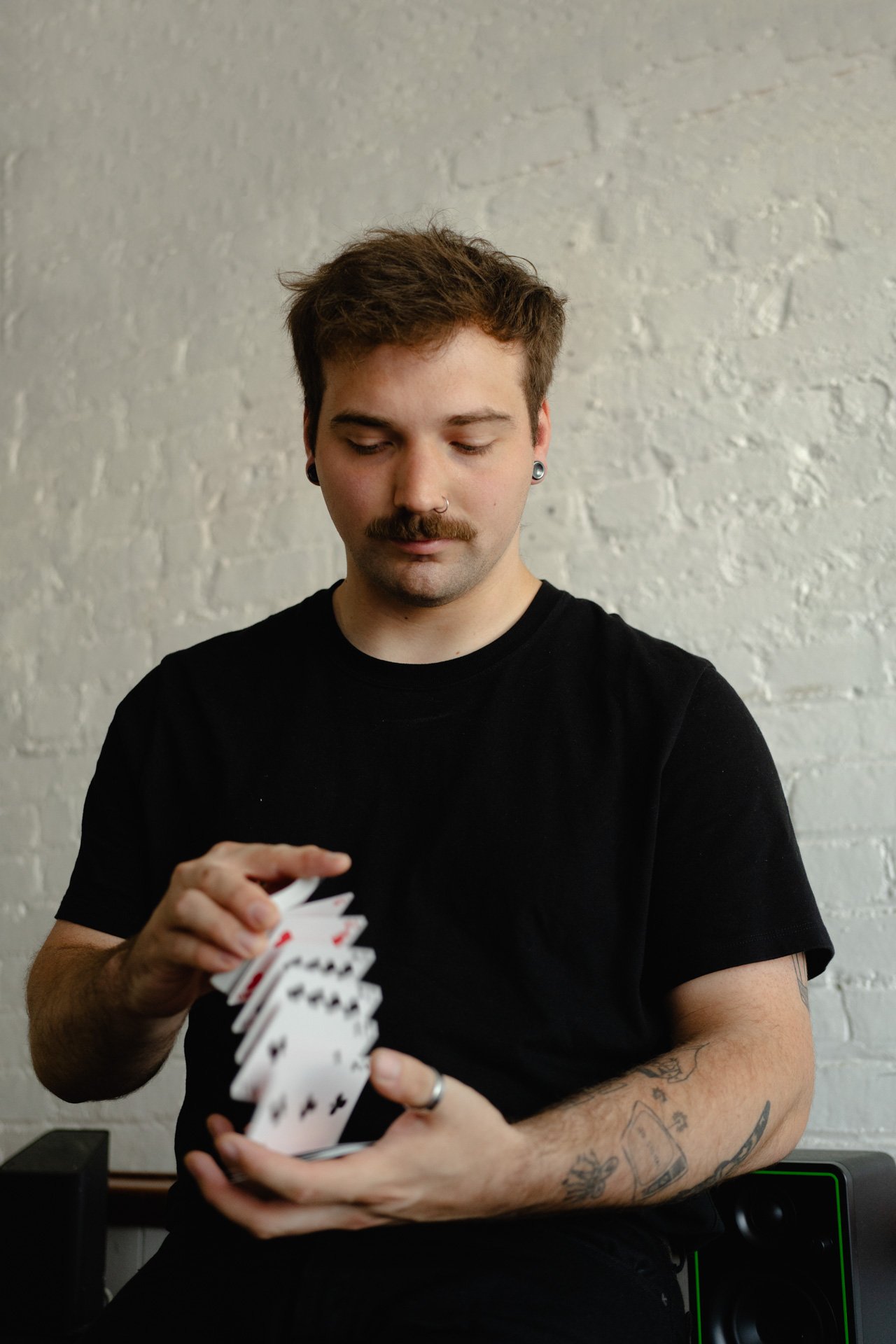 Kobe Wilson flourishing a deck of cards