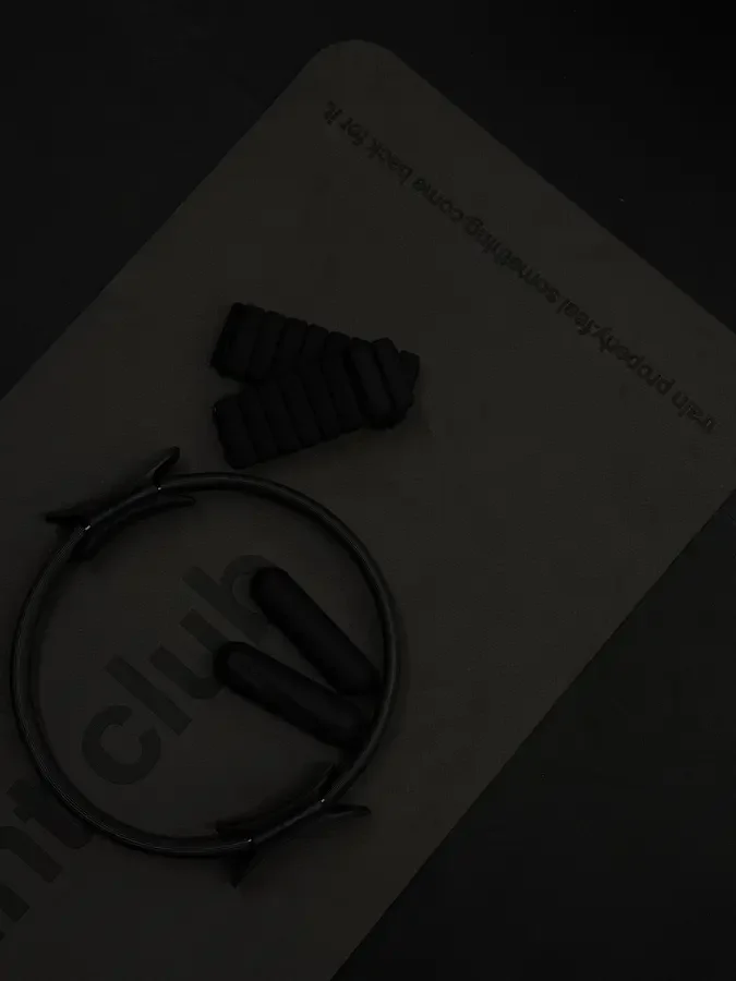 Pilates ring and weights on a mvmnt club mat