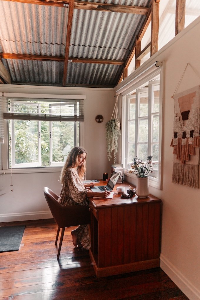 Woman working in calm home office, reflecting balanced lifestyle and holistic wellbeing Currumbin Valley Gold Coast