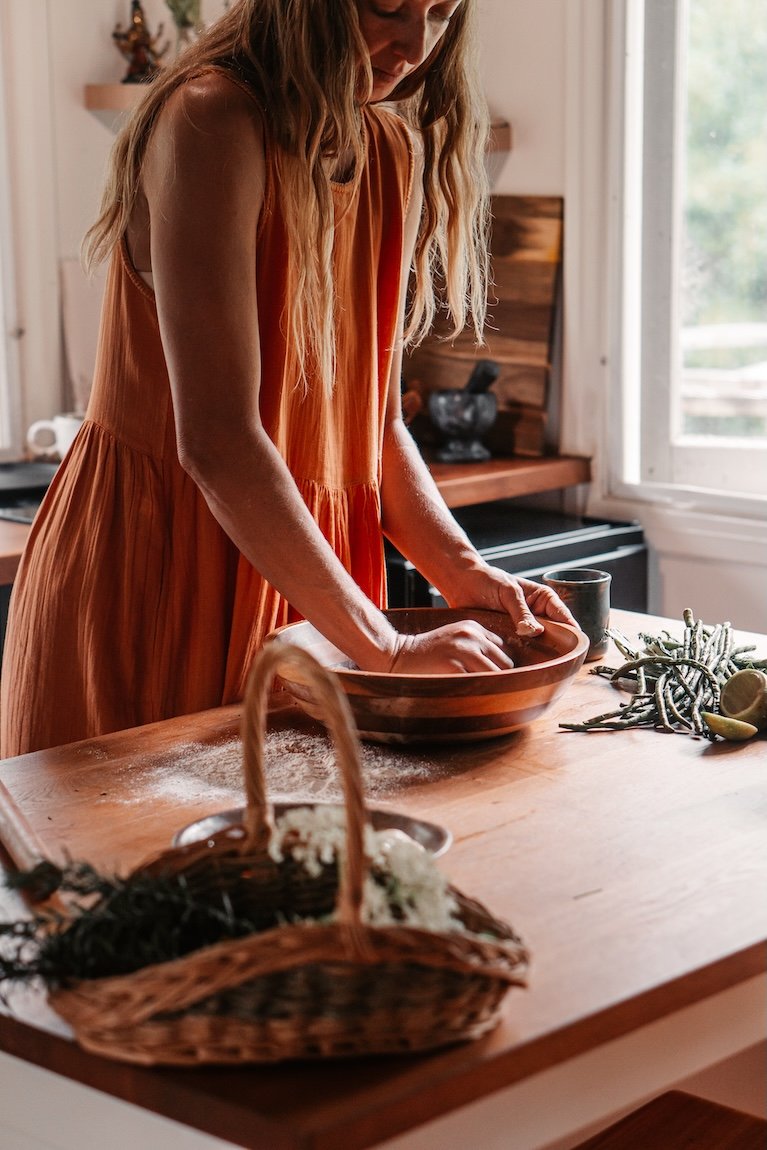 Woman preparing wholesome food, reflecting Ayurvedic nutrition and holistic health practices Gold Coast