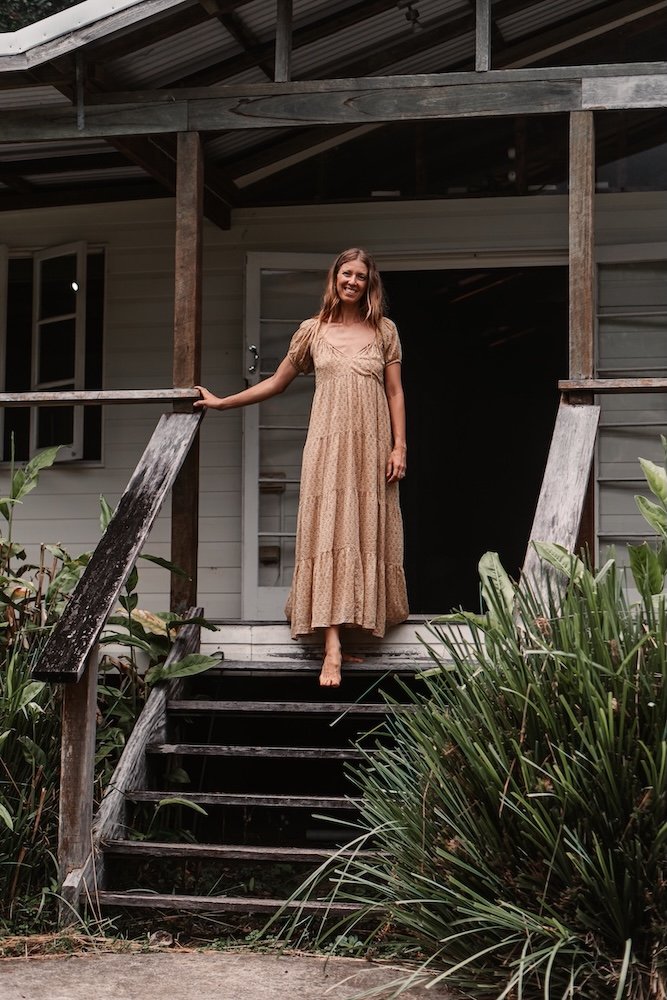 Woman standing barefoot at home, representing grounded lifestyle, balance and holistic wellbeing Gold Coast