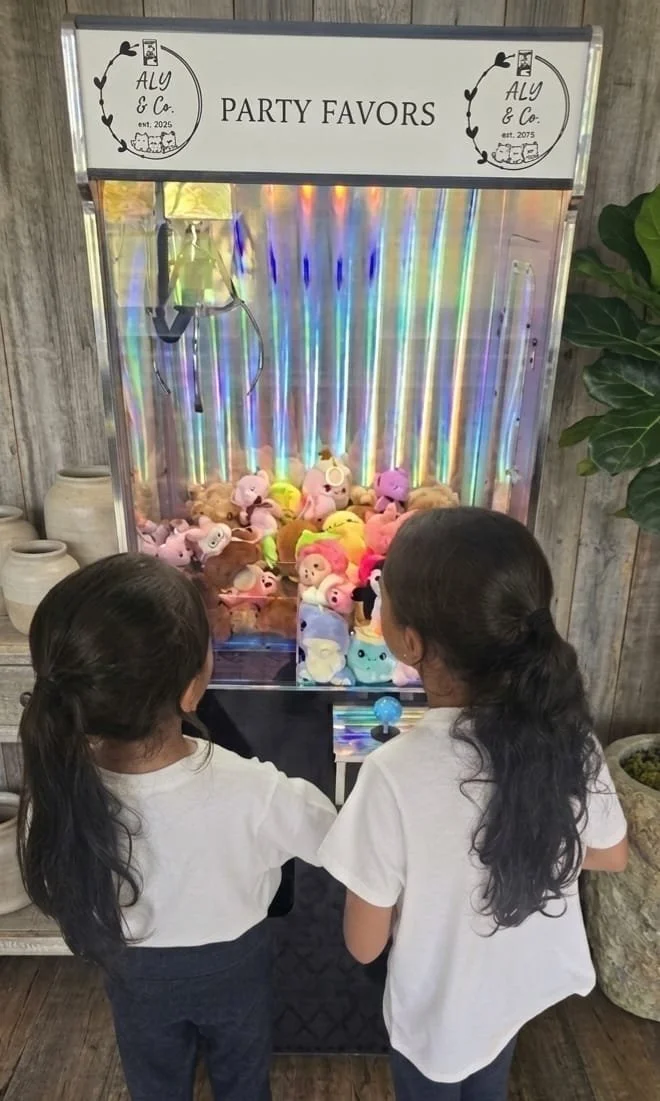 Image of two people using one of our claw machine services