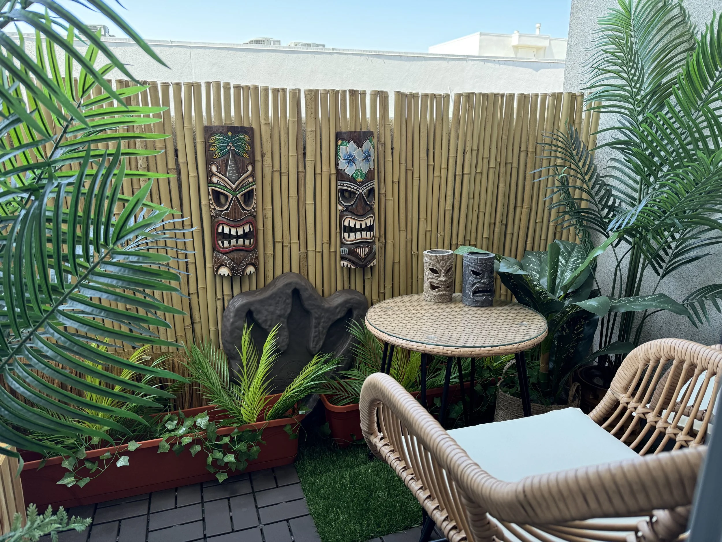 Daytime view of transformed tiki-inspired balcony environment