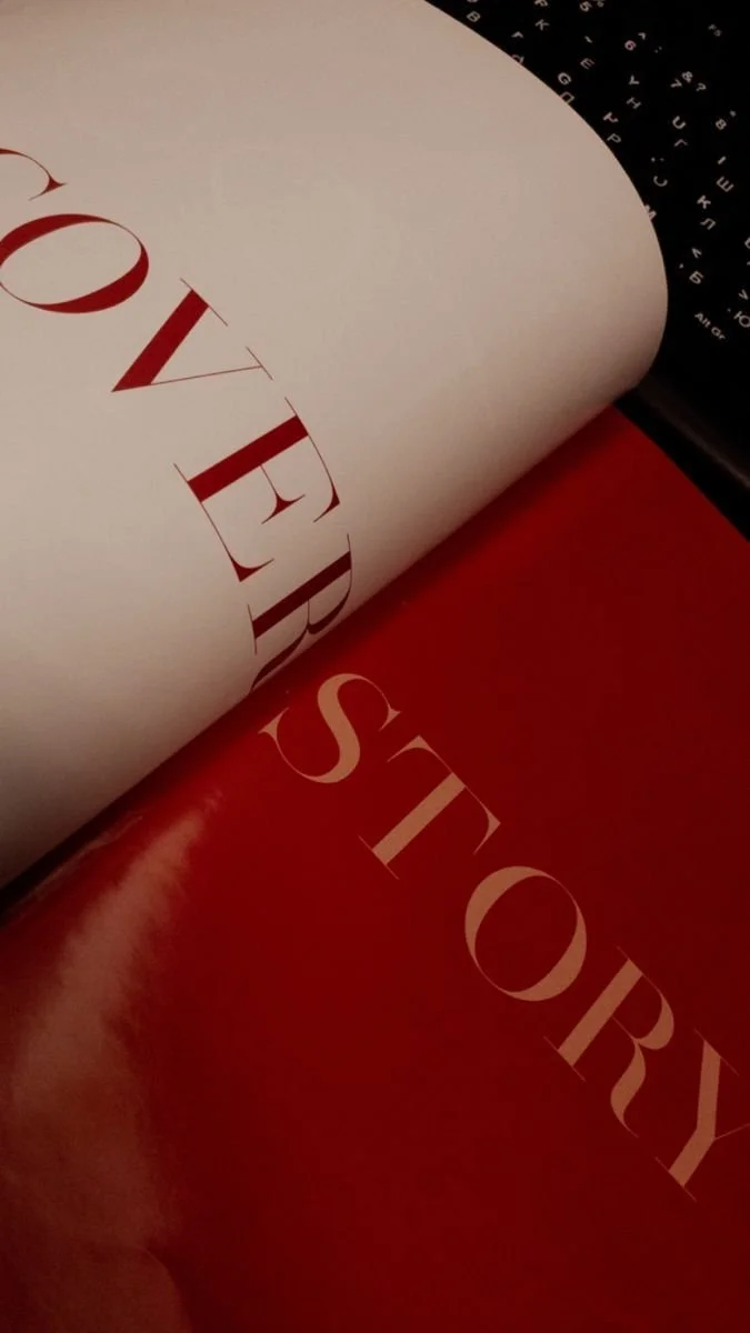 Close-up of a printed page with the words 'LOVE STORY' in large, elegant red and pink lettering on white and red backgrounds.