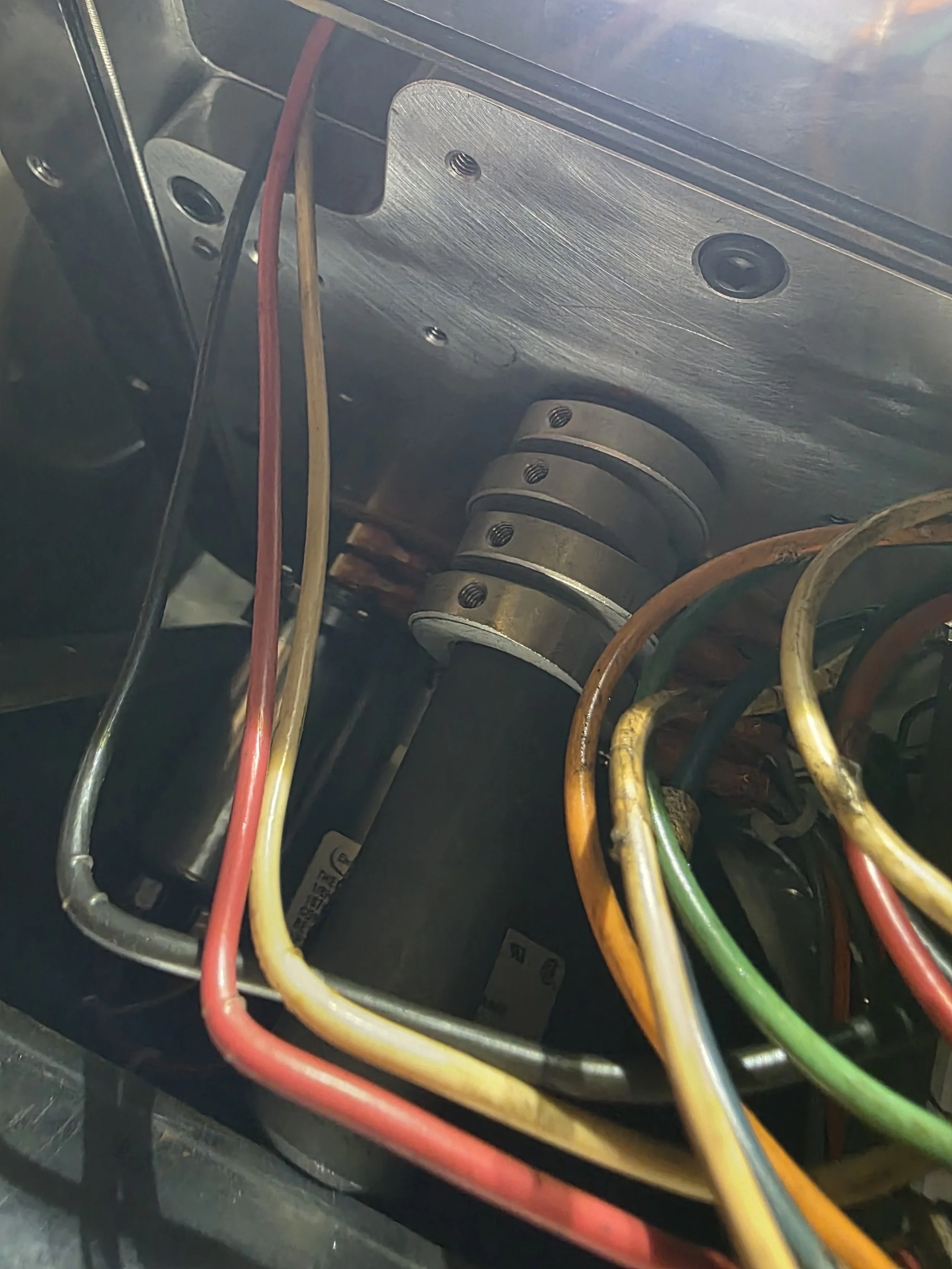 Close-up of colorful electrical wires connected inside an electrical panel or device.