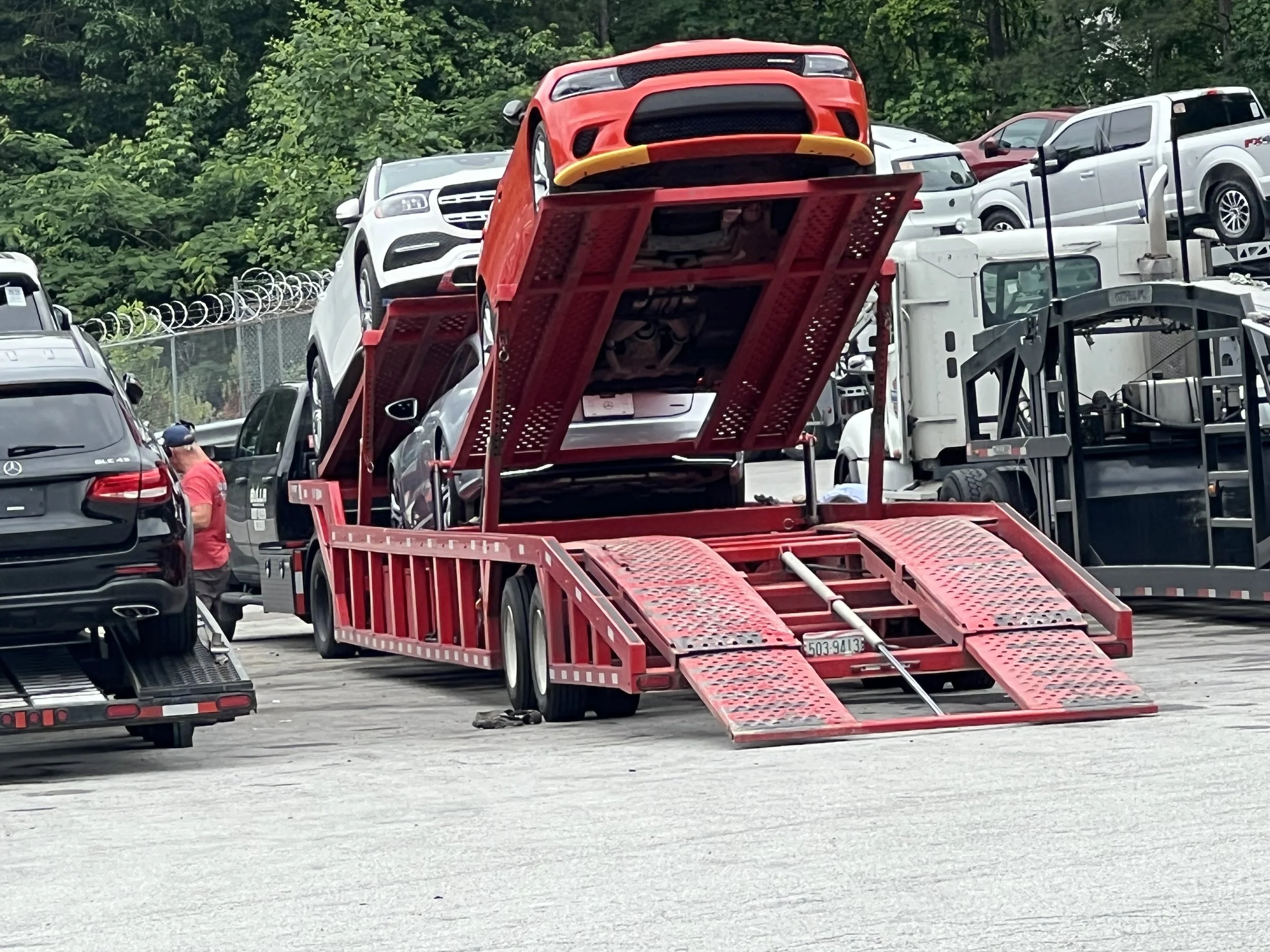 Vehicle being loaded onto an open car carrier for nationwide vehicle transport