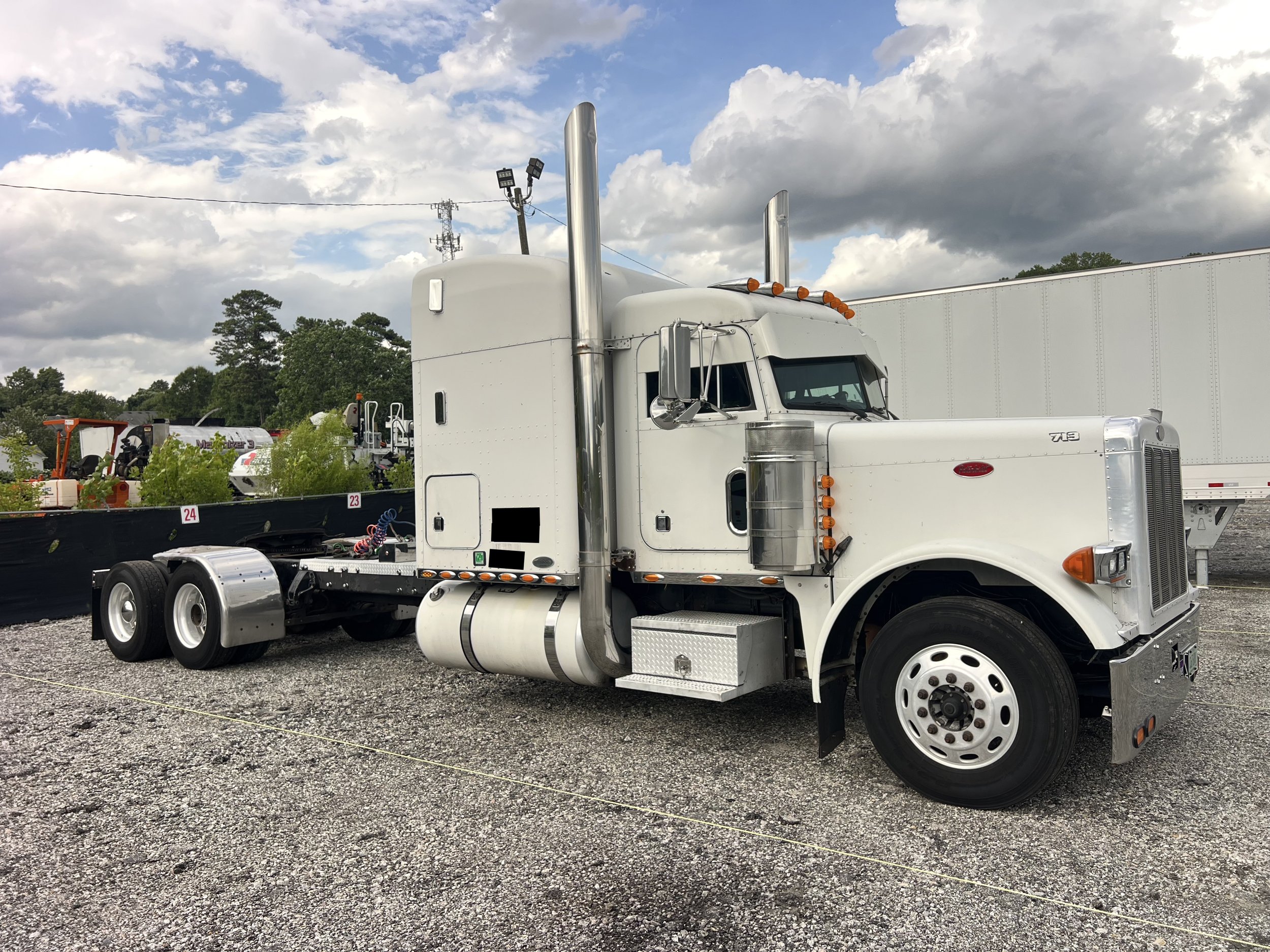 Passenger side front angle of 2003 Peterbilt 379 semi truck Double Frame Chassis
