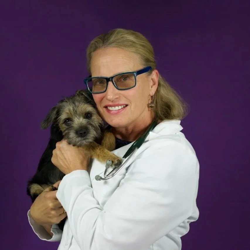 Dr. McCarthy, smiling with her dog