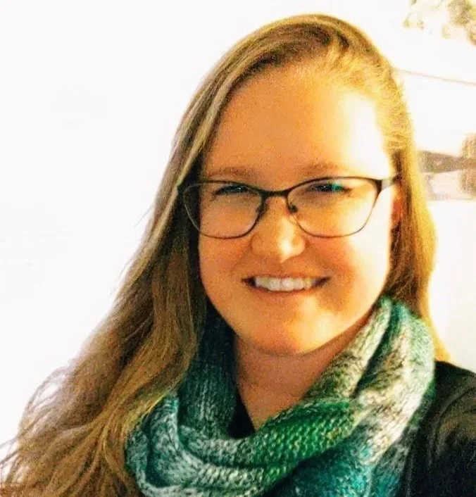 Aubri our practice manager, wearing a scarf and smiling