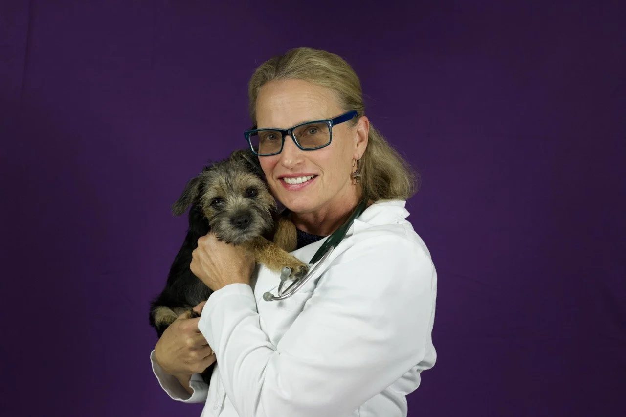 Dr. Therese McCarthy holding her dog and smiling