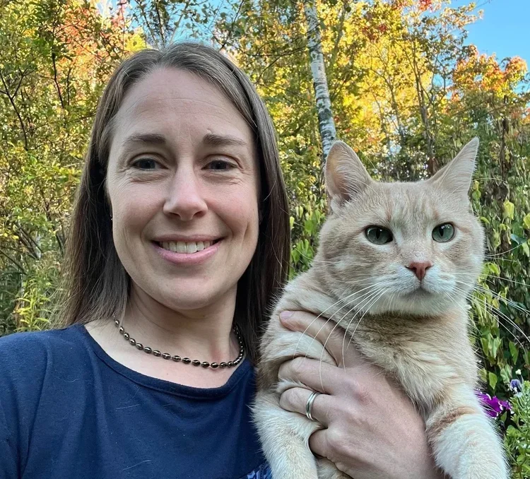 Dr. Sarah Myers smiling with her cat