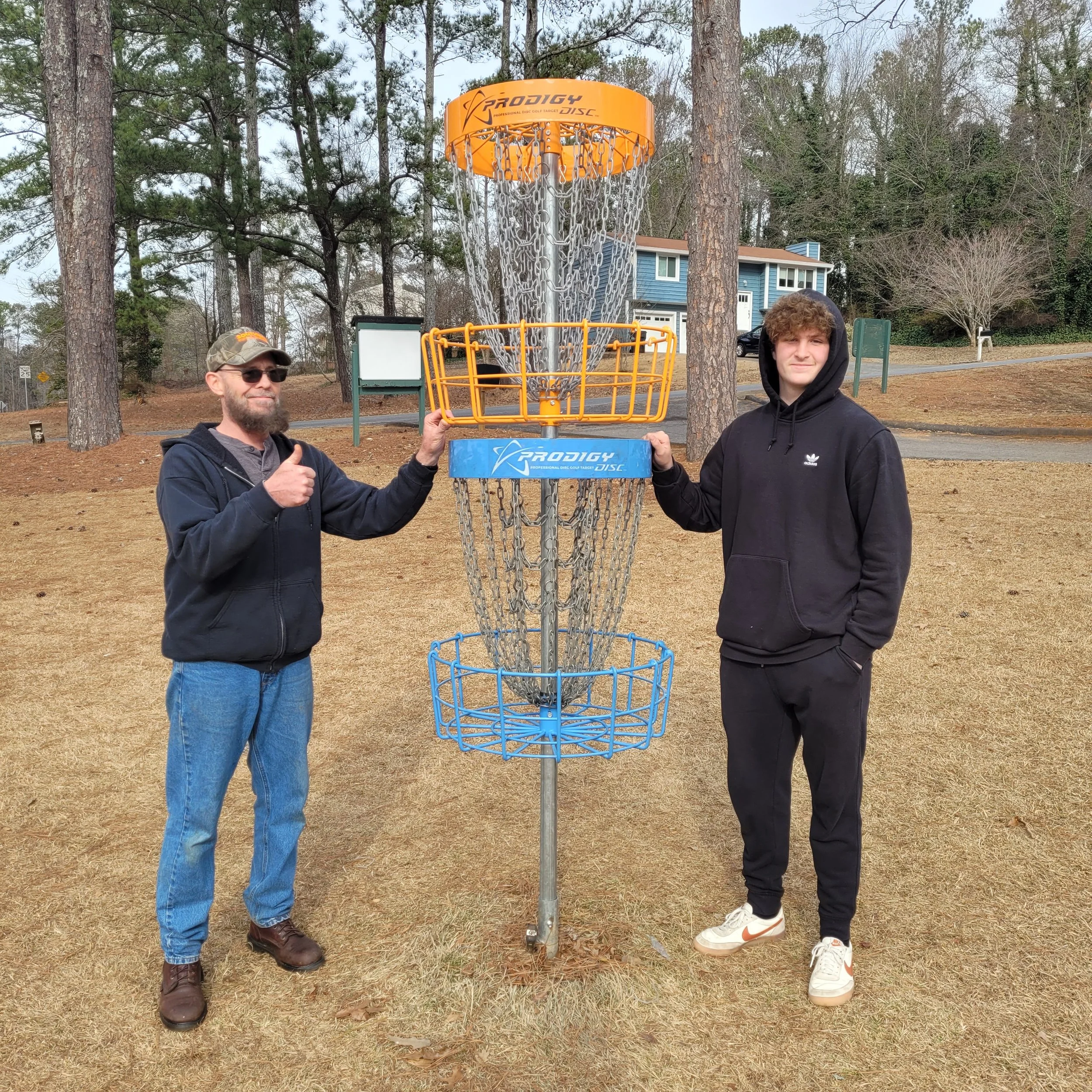 Joe and Thomas showing off their efforts on the new hole 16 double basket.