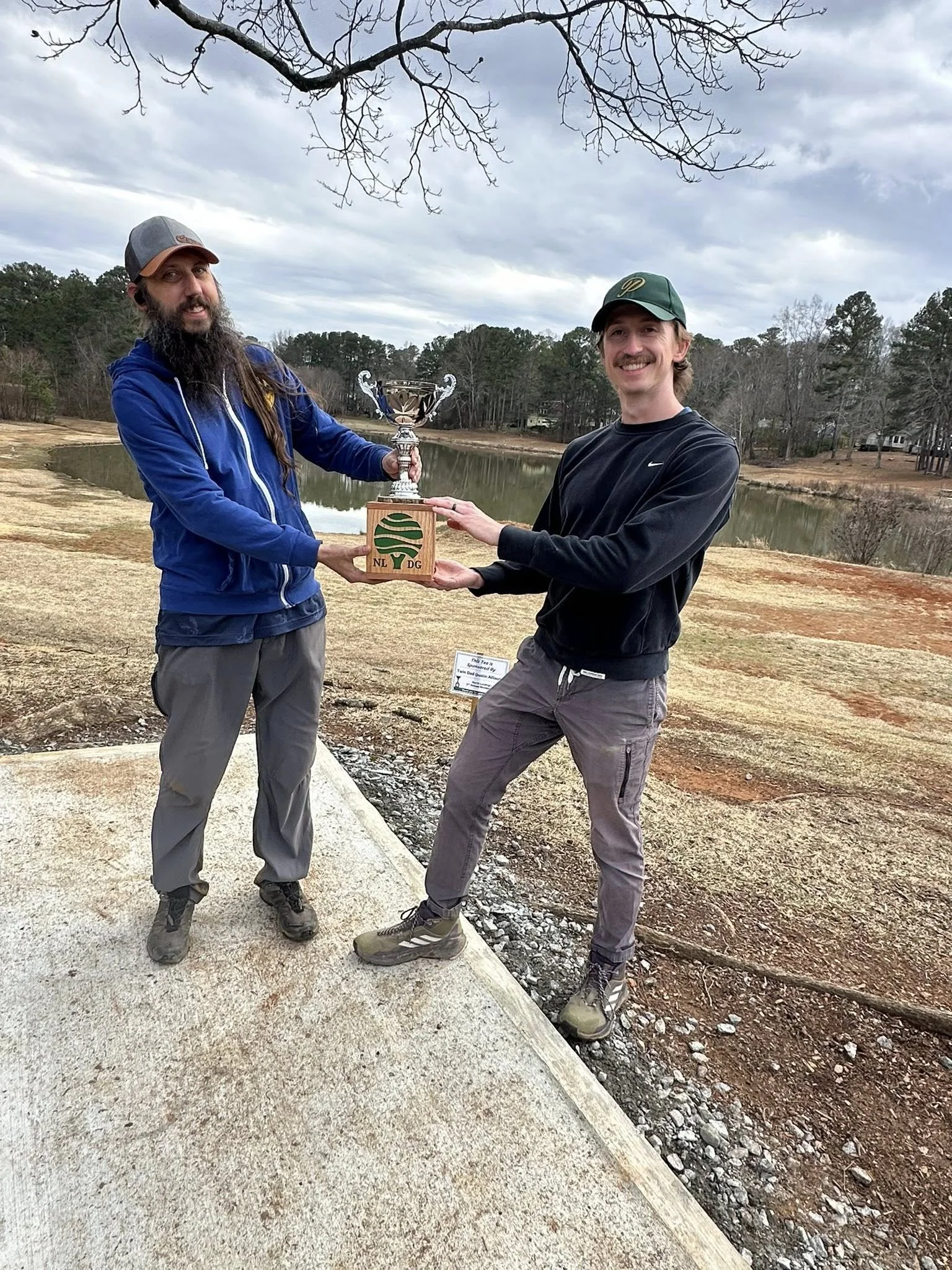 Al and Neal show off the North Landing Member's cup on a newly concreted tee #1.