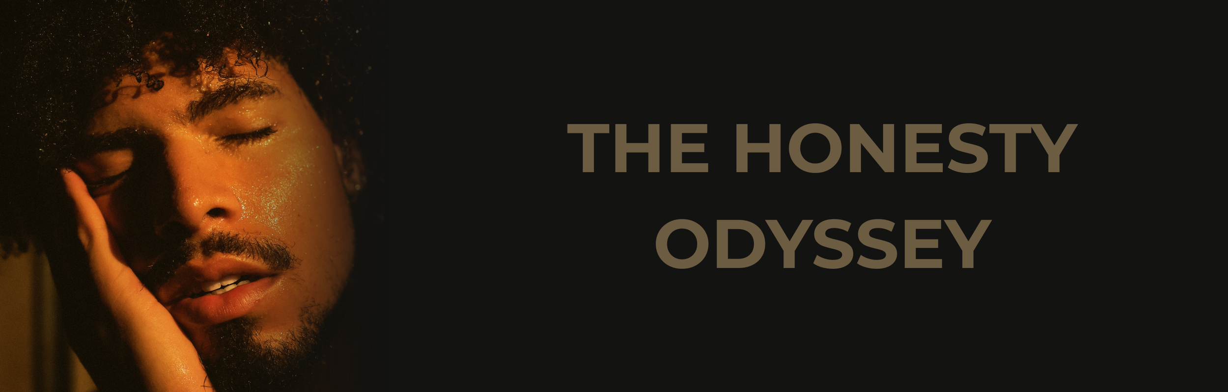 Close-up of a person with curly hair and a beard, eyes closed, touching their face with their hand, with warm lighting and golden particles on their skin, next to text that says 'The Honesty Odyssey'.
