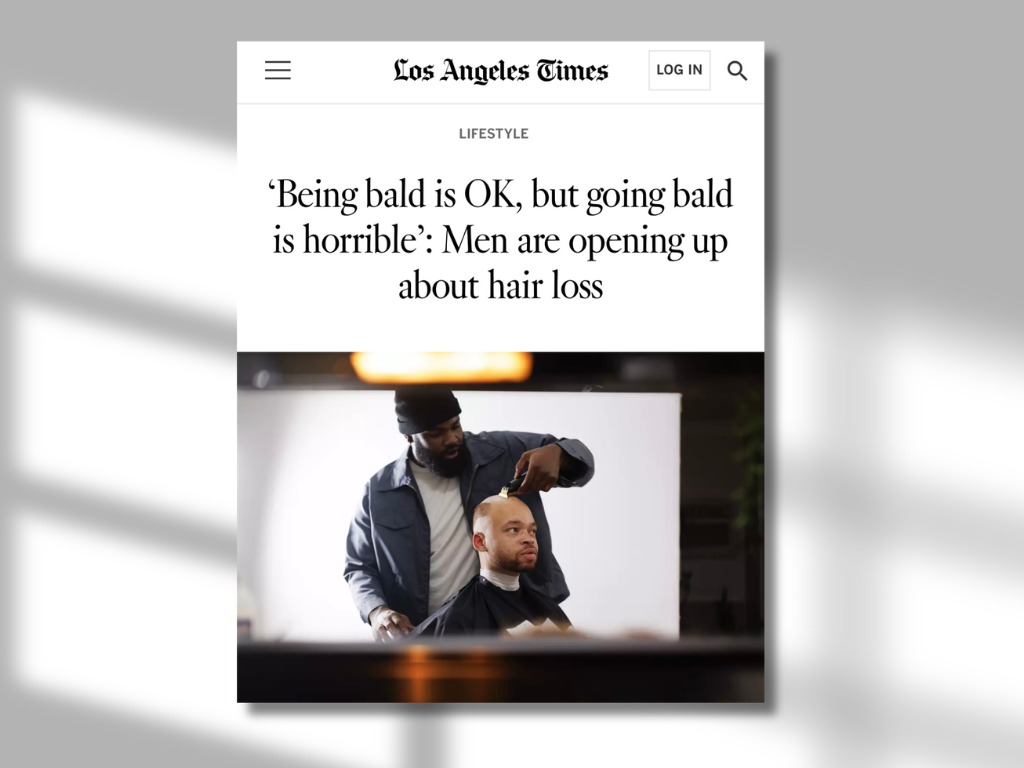 Screenshot of the Los Angeles Times website featuring a headline about hair loss and men going bald, with an image of a barber cutting a man's hair.