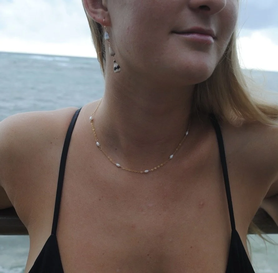 Twin Tides Collective gold filled  necklace with freshwater pearls modeled at the beach in Hawaii